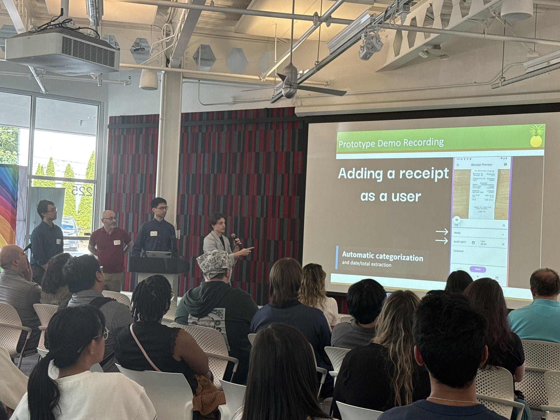 Pineapple Expense team presenting the project to an audience